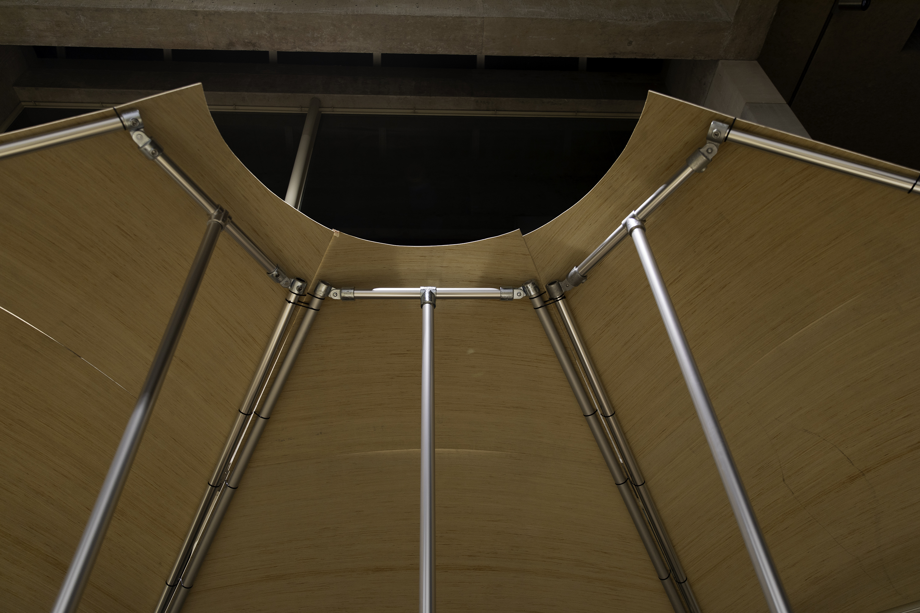 Looking up at three pavilion modules joined to form a hemicircle